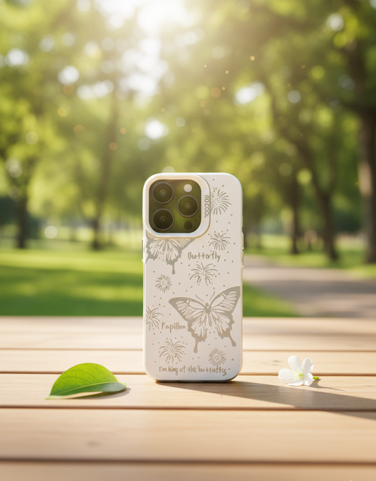 Phone case with butterfly design on a wooden surface in a park