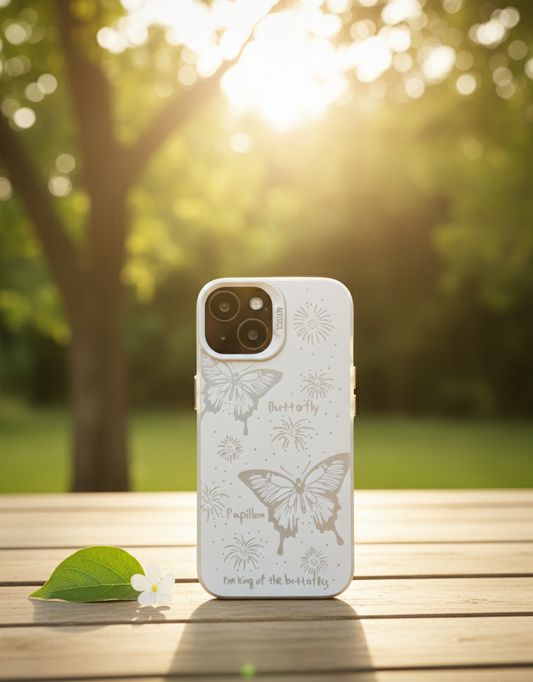 Phone case with butterfly design on a wooden surface with a natural background