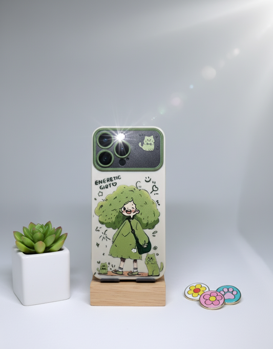 Phone case with cartoon design on a stand, next to a small plant and decorative items.